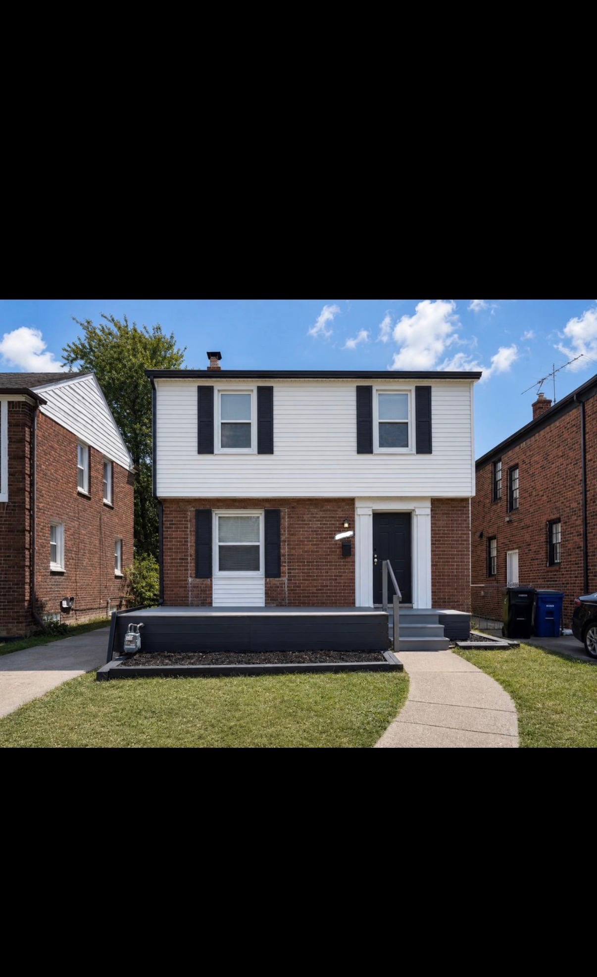 House exterior after renovation, fresh trim, new deck and steps