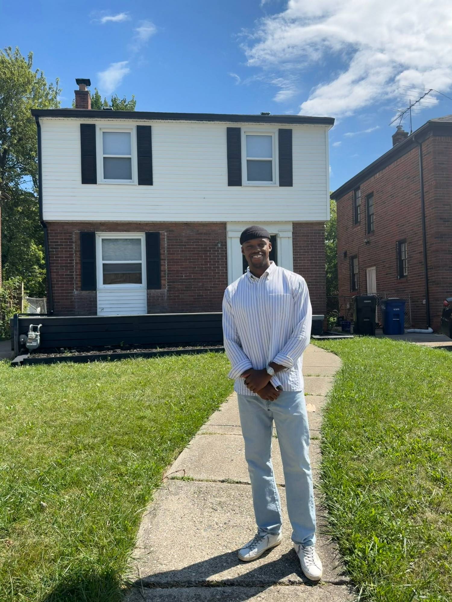 Nick, owner of Vivify Investments LLC, standing in front of a home he purchased in Metro Detroit